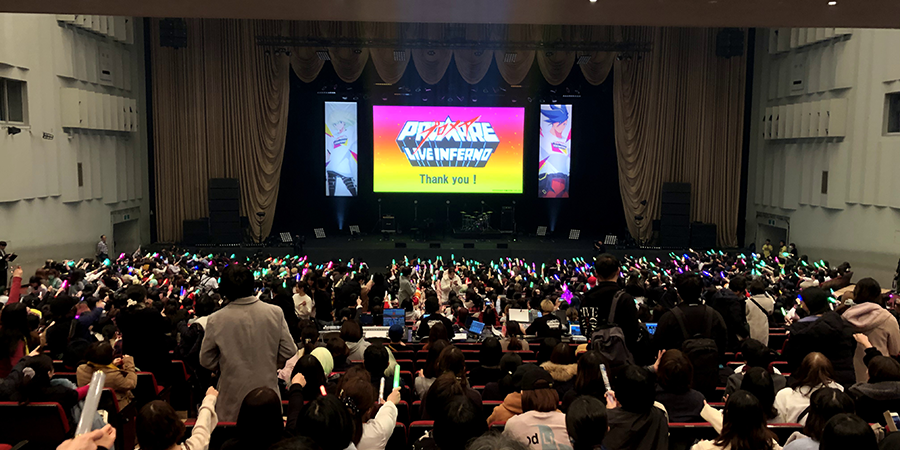 Enthusiastic fans cheering at the screening of PROMARE